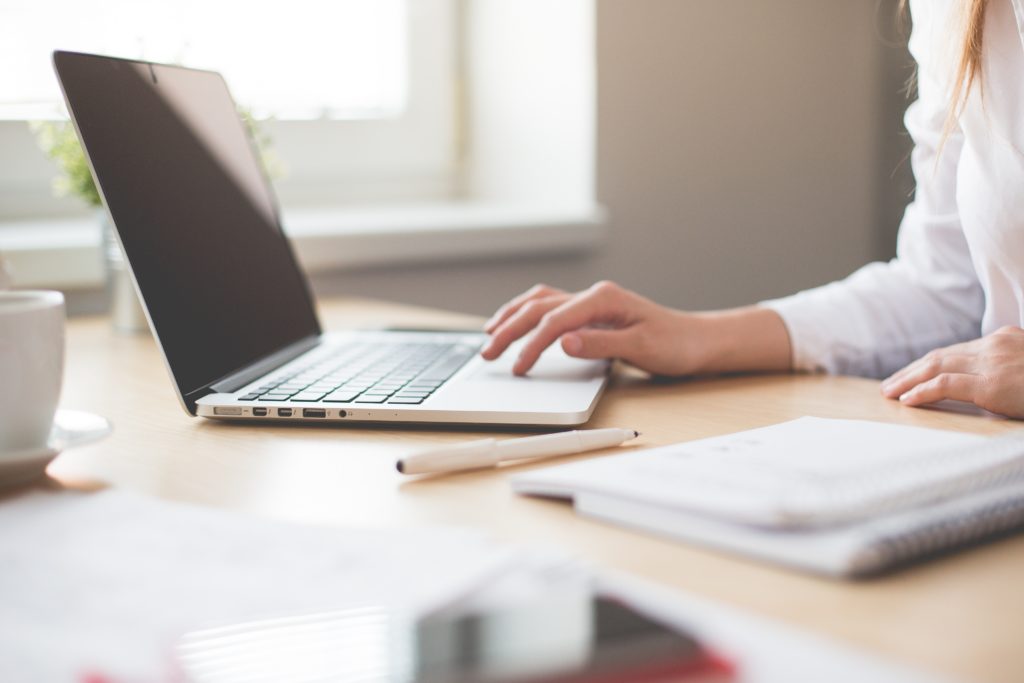 Close up of a woman using a laptop computer