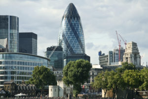 Modern glass buildings including the Swiss Re Gherkin in London's Financial District.