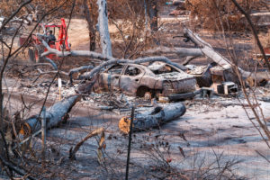 A property and a car wiped out by a wildfire.