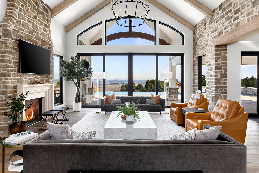A beautiful luxury home featuring stone accents, vaulted ceilings, and a fireplace.
