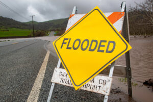 A road closed, flooded, sign.
