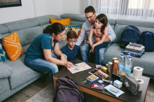 A family discusses their evacuation plan while preparing their emergency "go-bags."